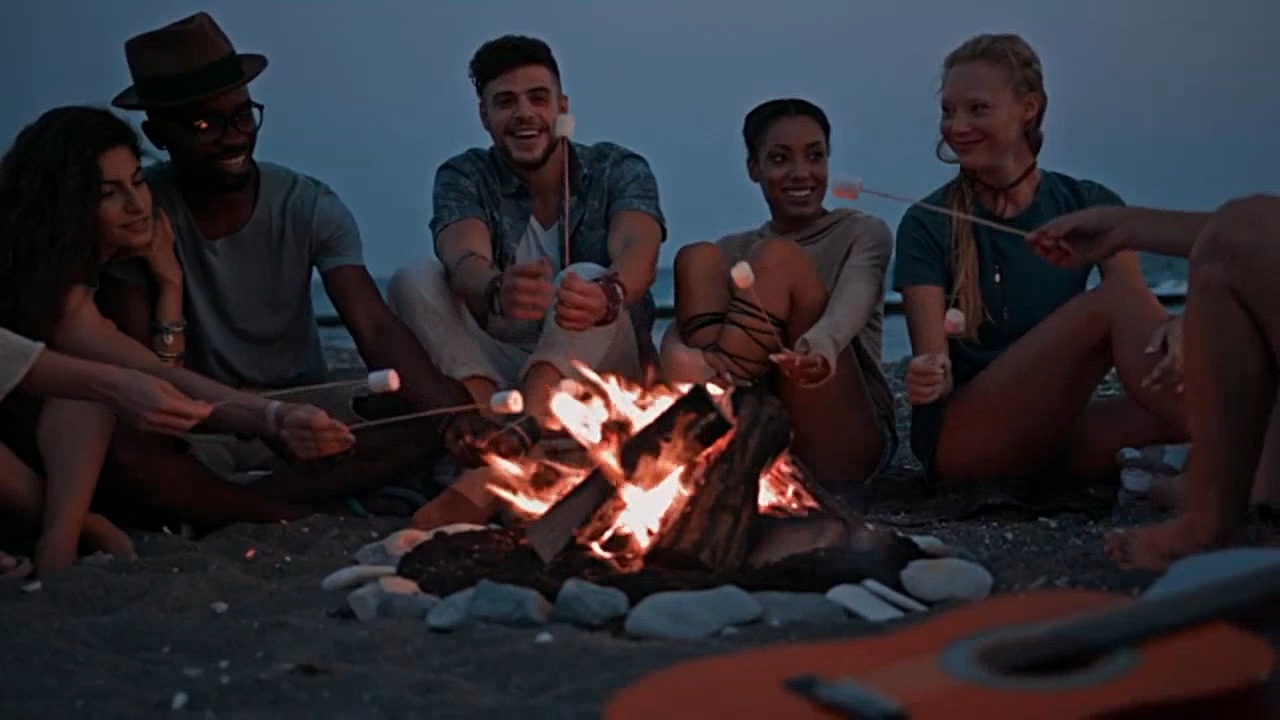 Friends sitting around a campfire